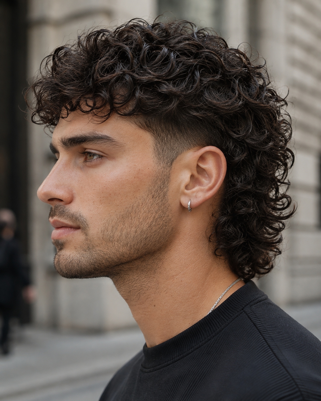 Curly modern mullet for men with a clean fade
