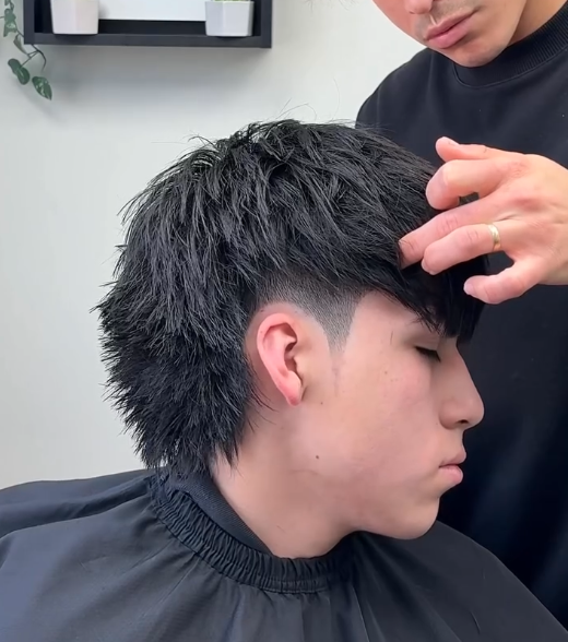 a guy with a modern mullet back texture straight black hair