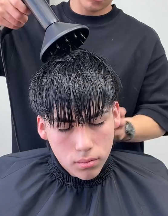 blowdrying hair with mullet