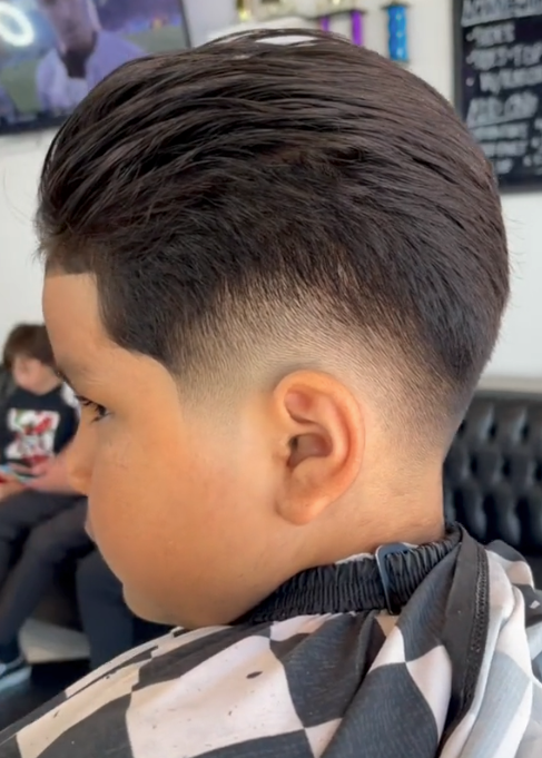 boy with a fade and slicked back hair