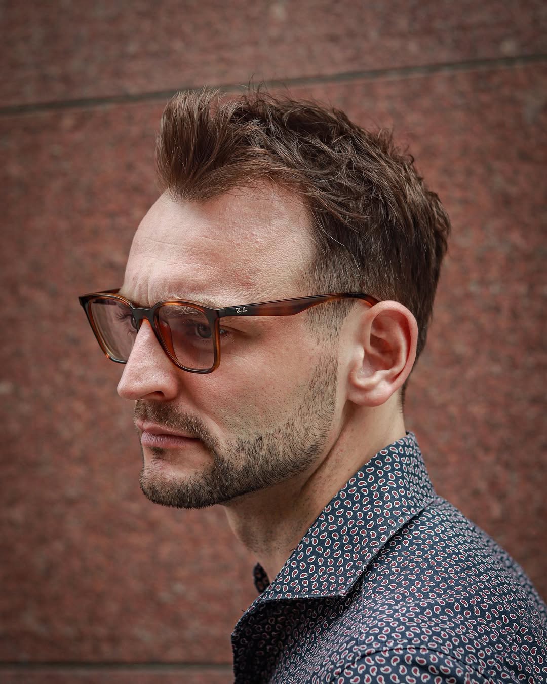a guy with thinning hair and a messy quiff hairstyle