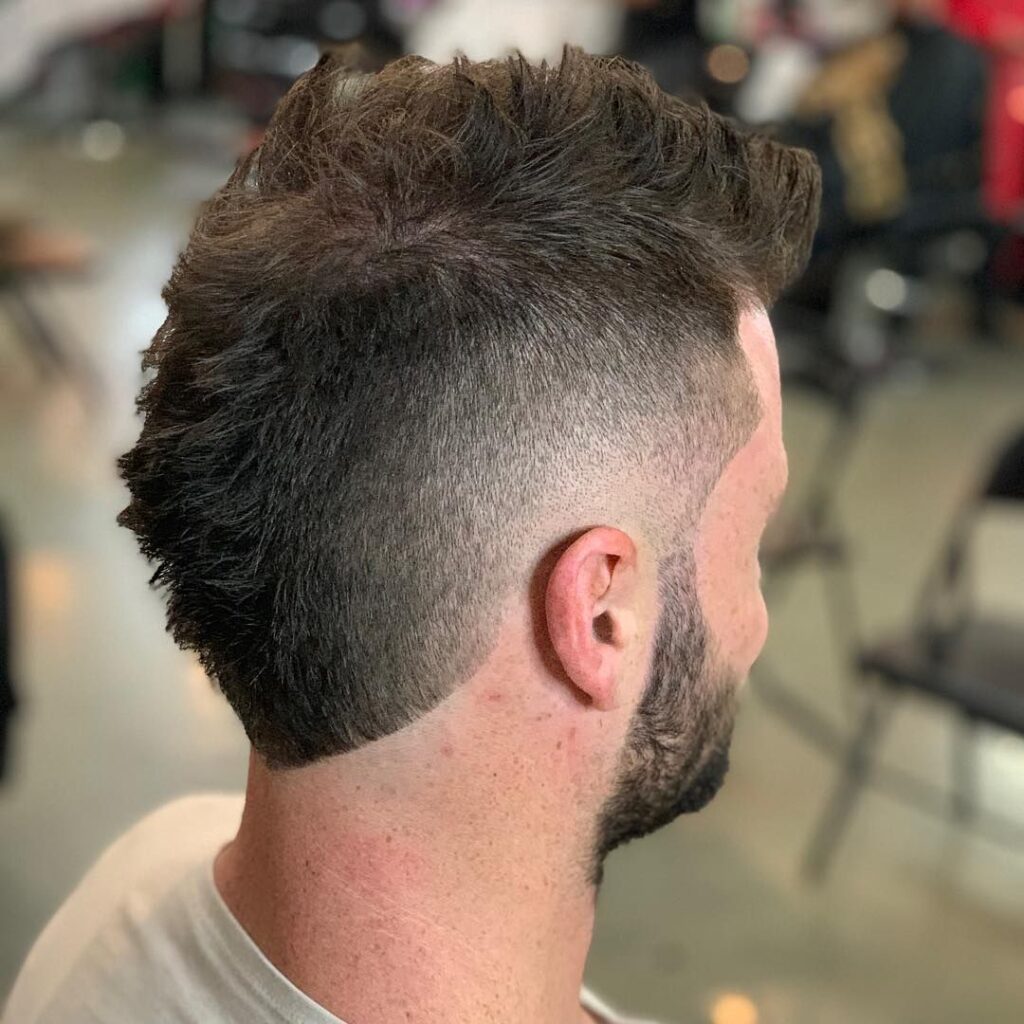 a guy with a faux hawk mullet