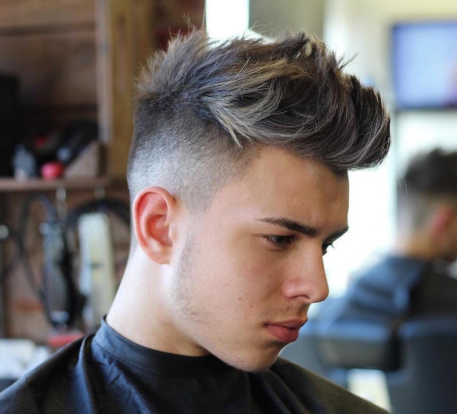 a guy with a messy quiff with blonde highlights