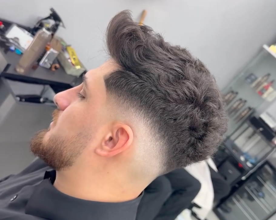 a textured quiff with a mid fade