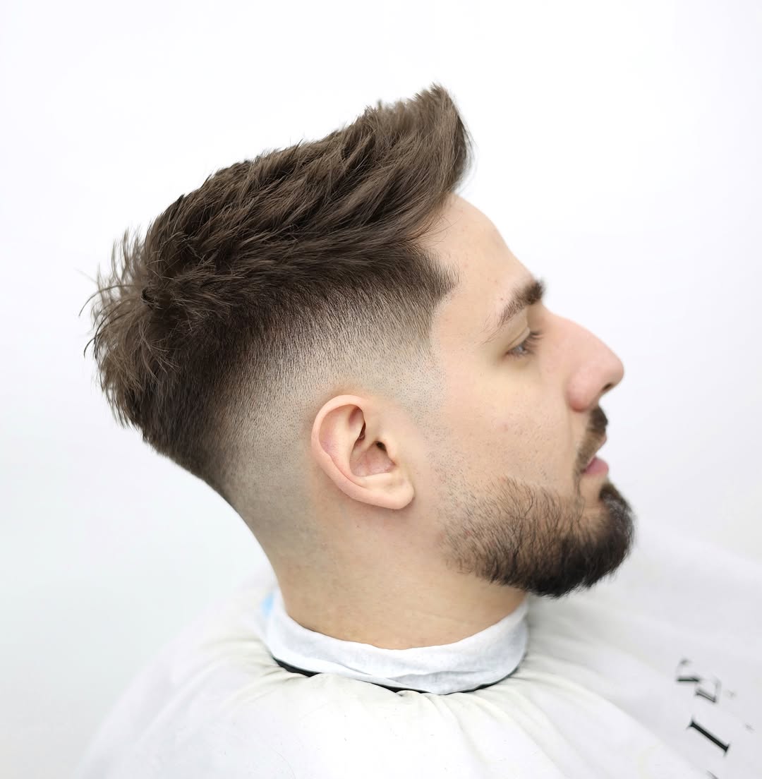 a man with a beard a drop fade and quiff haircut styles