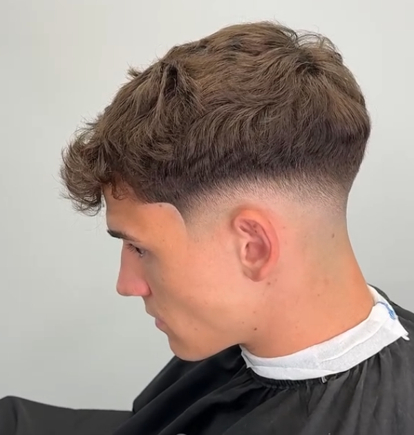 a guy with a classic mid fade haircut