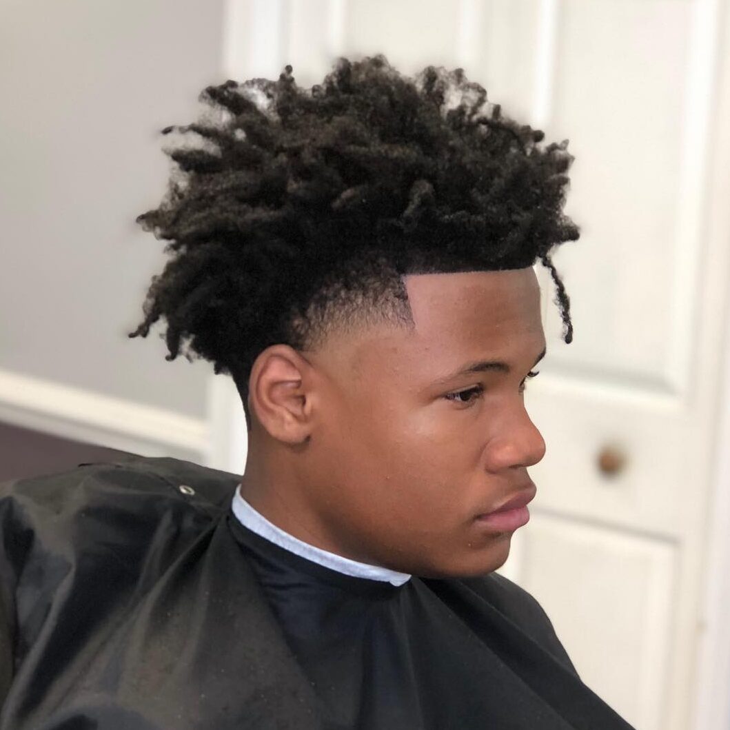 dreads and mid taper fade
