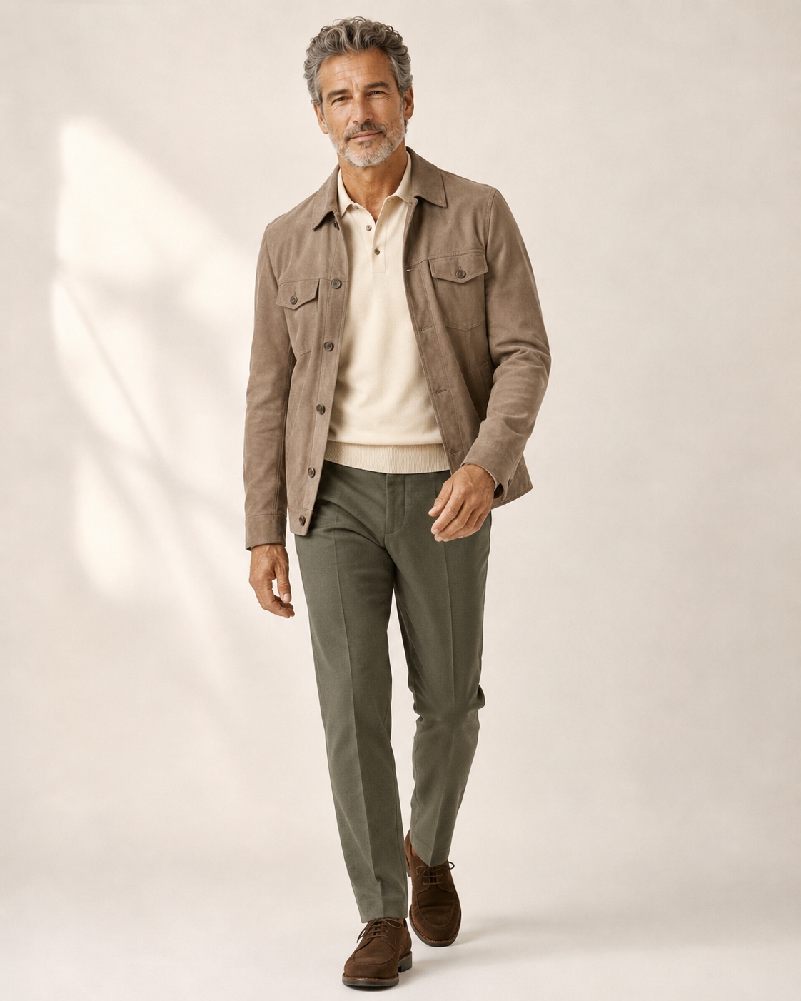 Casual outfit for a man over 50 with a taupe suede jacket, cream polo, olive trousers and brown shoes