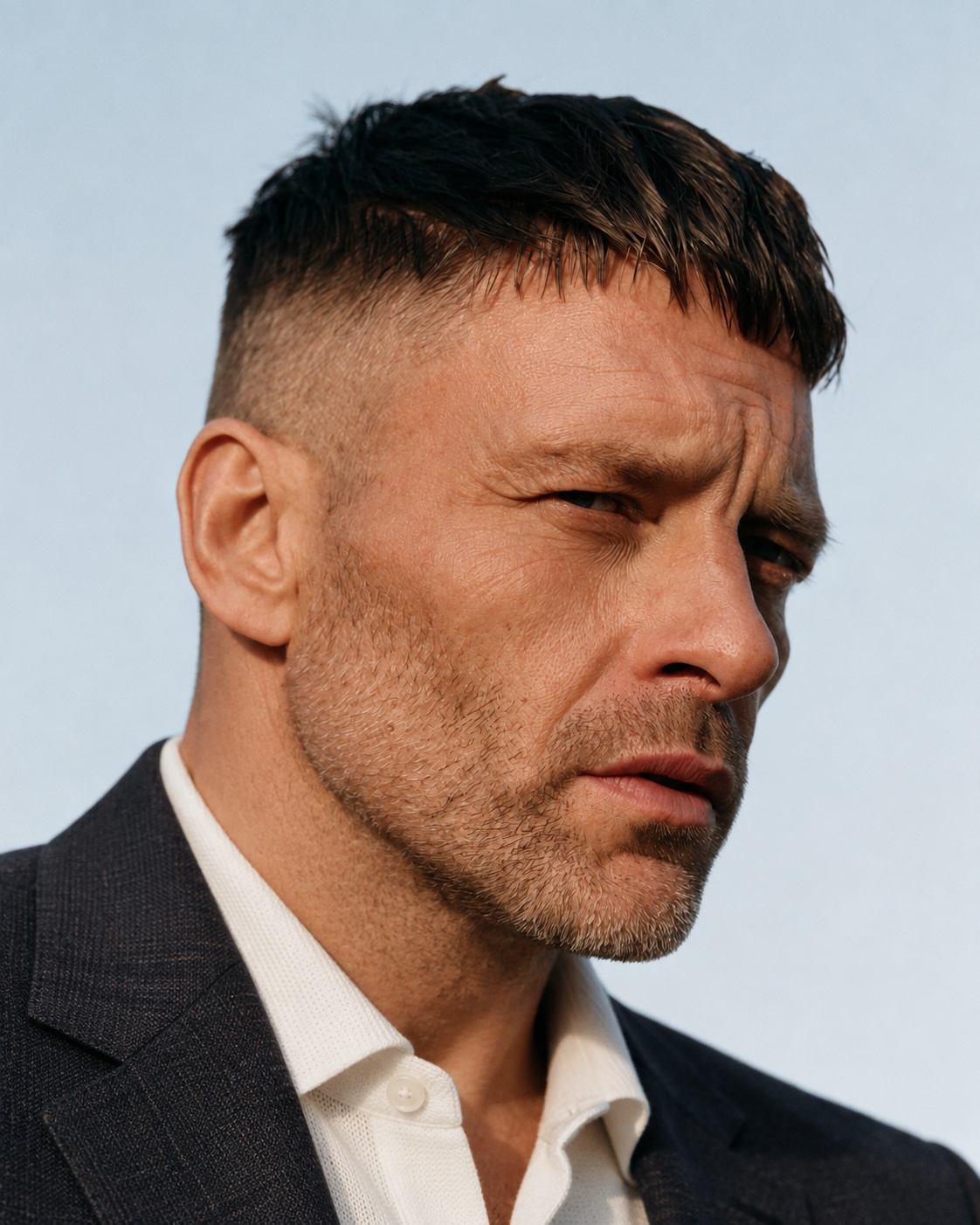 Textured crop with forward fringe and skin fade, worn with a suit